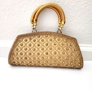 Vintage classic beaded gold rhinestone purse with gold trim handles.